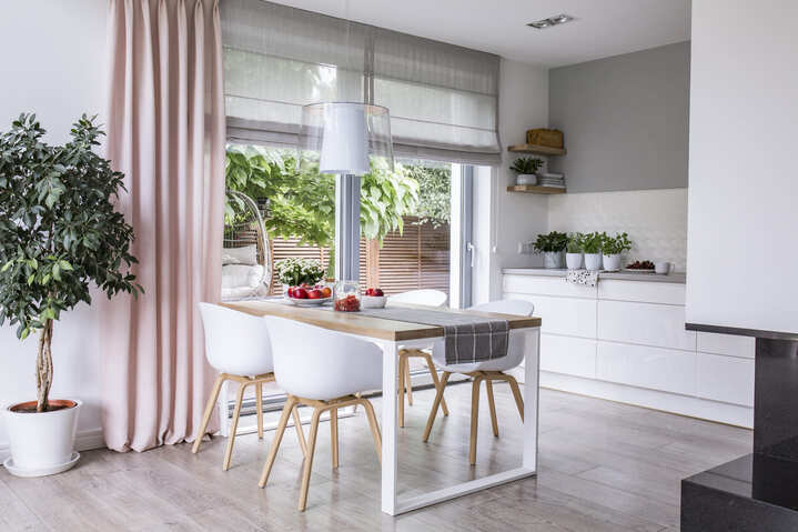 gray-roman-shades-and-a-pink-curtain-on-big-glass
